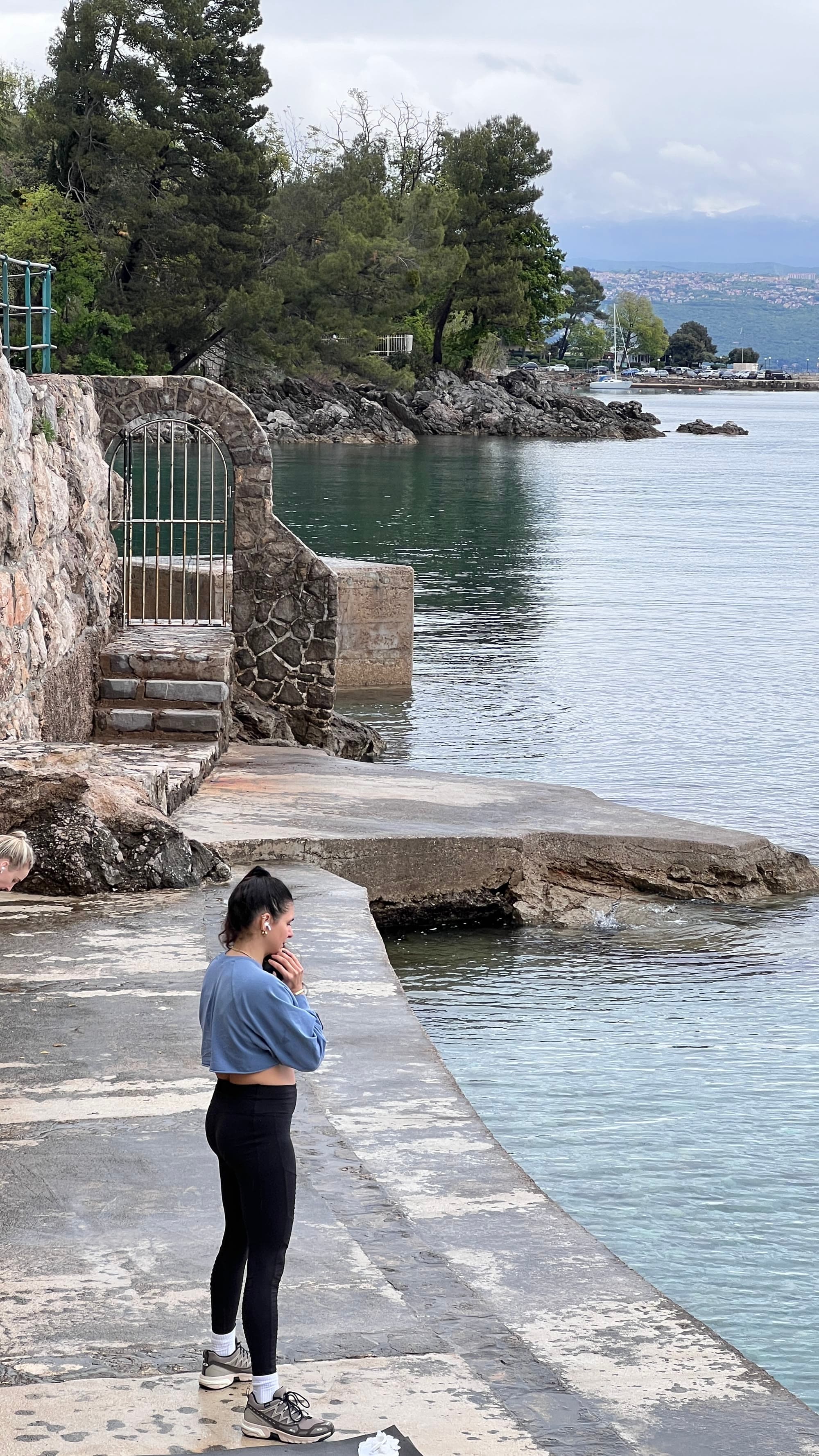 A participant standing at the water’s edge, looking out.